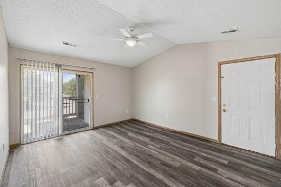 A room with a sliding glass door and a white door.