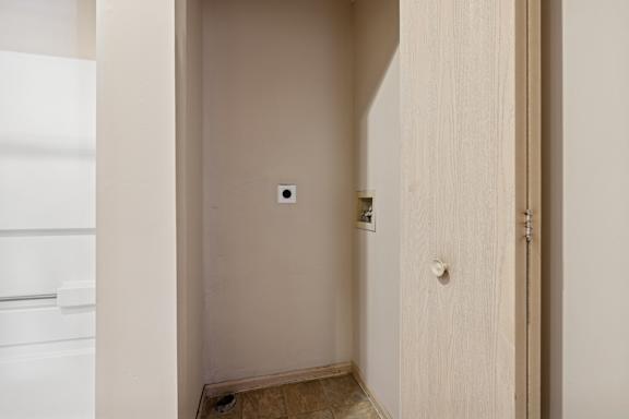 A small white door with a handle and a lock.