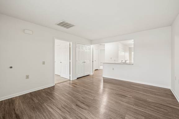 A room with white walls and wood flooring.