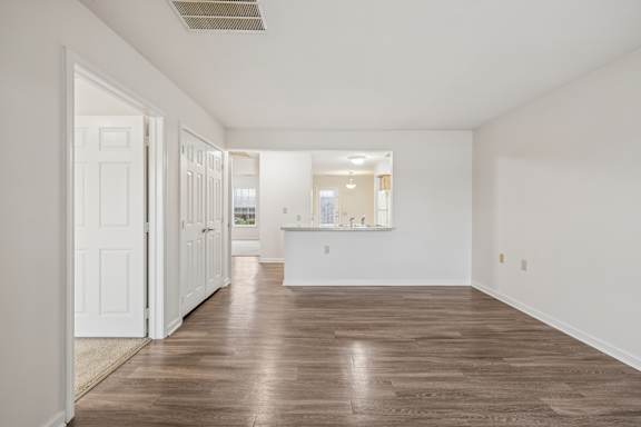 A room with white walls and wooden flooring.