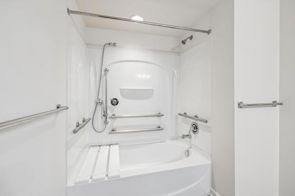 A white bathroom with a tub and shower.