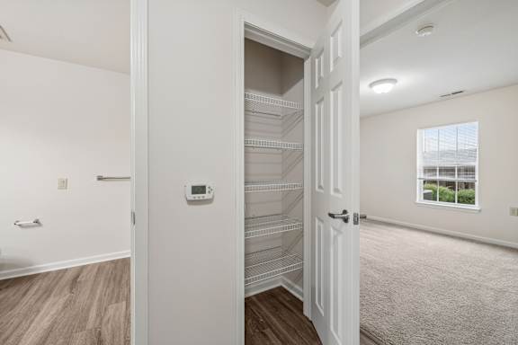 A white door with a window in the background.