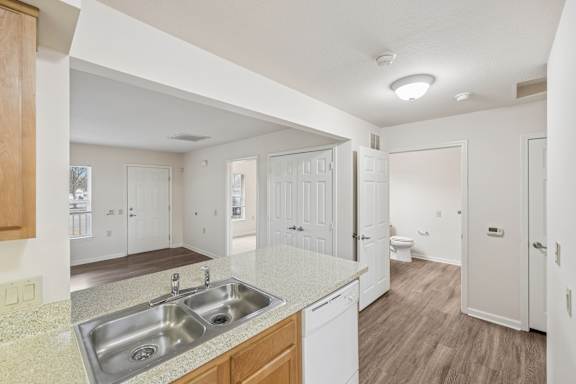 A kitchen with a sink and a counter top.
