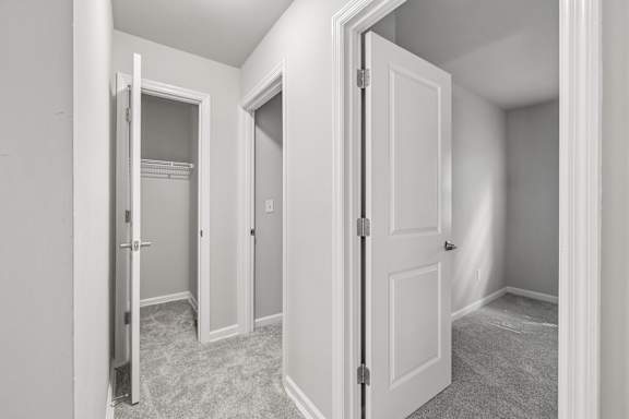 A white door is open to a hallway.