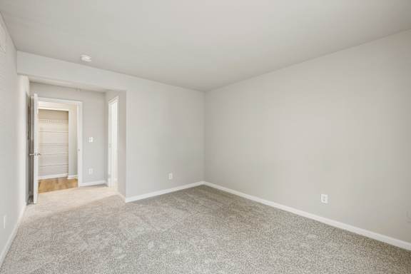 A room with a carpeted floor and white walls.