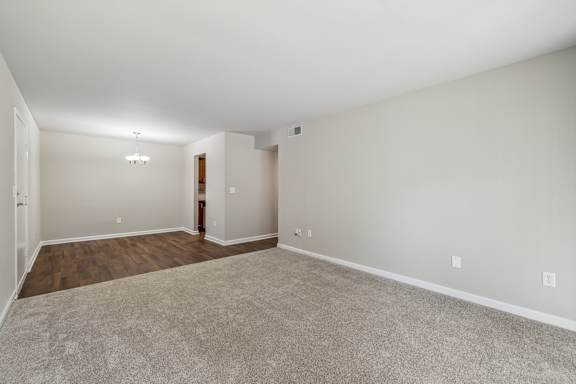 Empty room with carpeted floor and white walls.