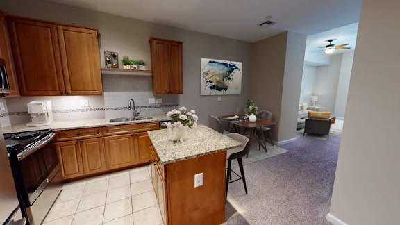 Kitchen with island and open living area at Renaissance at the Power Building Apartments, Cincinnati, 45202