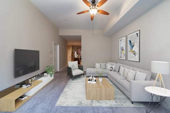 Modern living room with vaulted ceiling and sectional sofa at Renaissance at the Power Building Apartments, Cincinnati, Ohio
