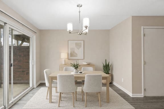 A dining room with a table set for four.
