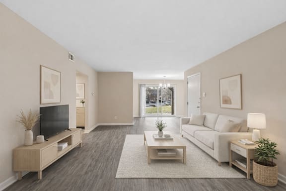 A living room with a television, couch, and coffee table.