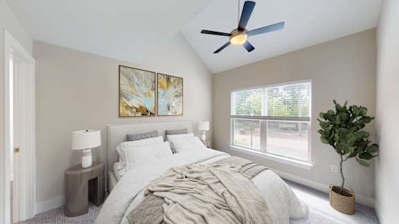 A bedroom with a bed, a ceiling fan, and a window.