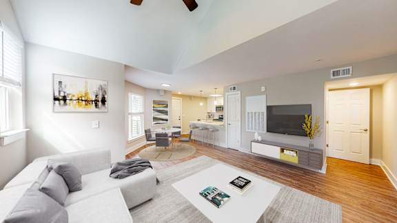 A living room with a grey couch and a television.