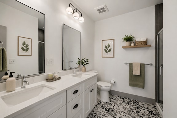 A bathroom with a white sink, toilet, and a mirror.