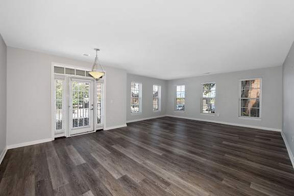 A room with wooden floors and white walls. at Roebling Row, Covington