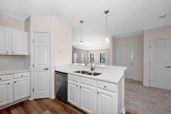 A kitchen with white cabinets and a sink. at Roebling Row, Covington, KY