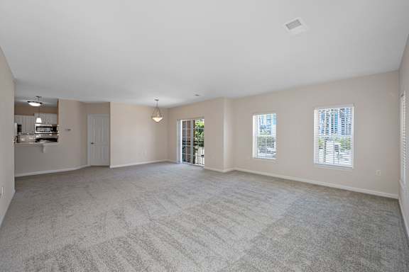 A spacious room with a carpeted floor and a door leading to another room. at Roebling Row, Kentucky, 41011-1720
