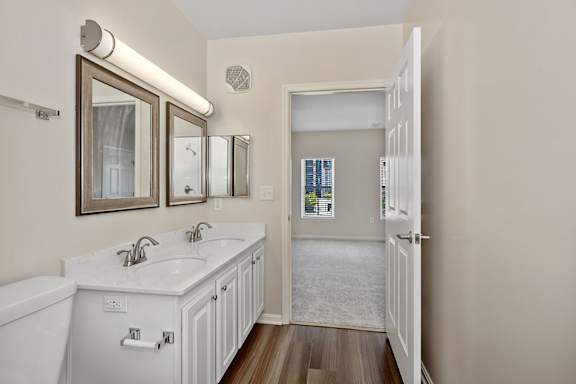 A bathroom with a white tub and sink. at Roebling Row, Covington, KY, 41011-1720