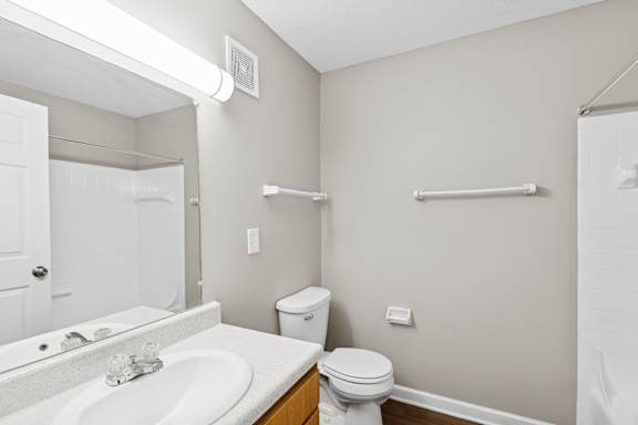 A white toilet sit with water tabs at Waterfront Pointe, Indiana