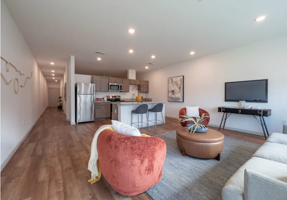 A modern living room with a red chair in the center.