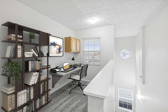 A room with a desk, chair, and bookshelf.