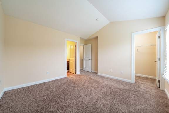 A room with carpeted floor and white walls.