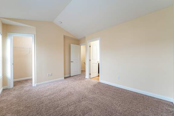 A room with carpeted floor and white walls.