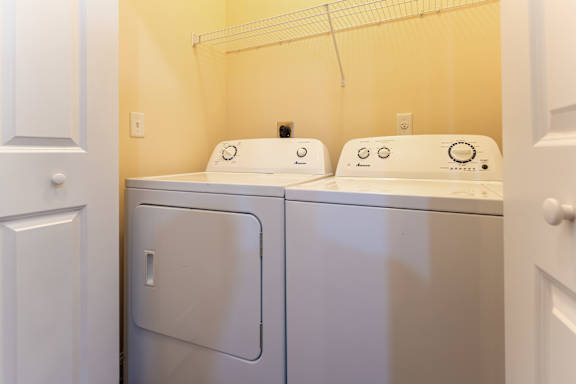 A small laundry room with a washer and dryer.