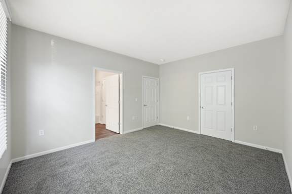 A room with a carpeted floor and white walls.
