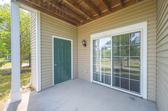 A small house with a green door and a glass window.