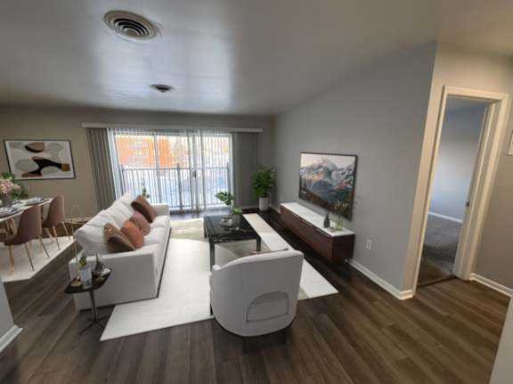 A modern living room with a white sofa and a coffee table.