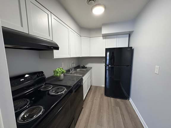 A black stove top oven with a pot on it.