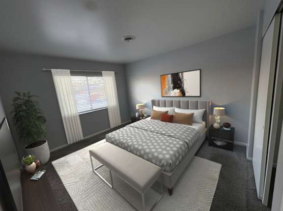 A modern bedroom with a large bed and a potted plant.