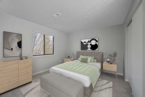 Bedroom with bed and lamp at The Reserve at Grand Valley, Milford, OH