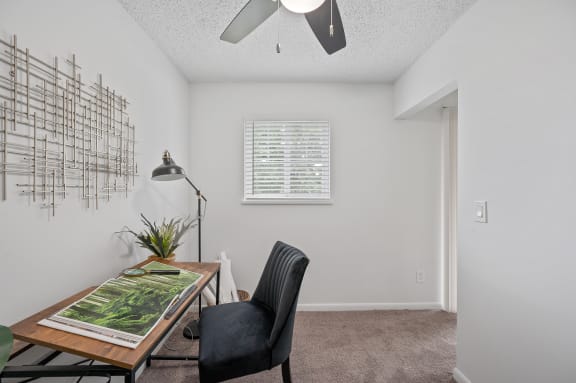 an office with a desk and a chair and a window