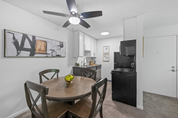 our modern kitchen and dining area with a table and chairs and a tv