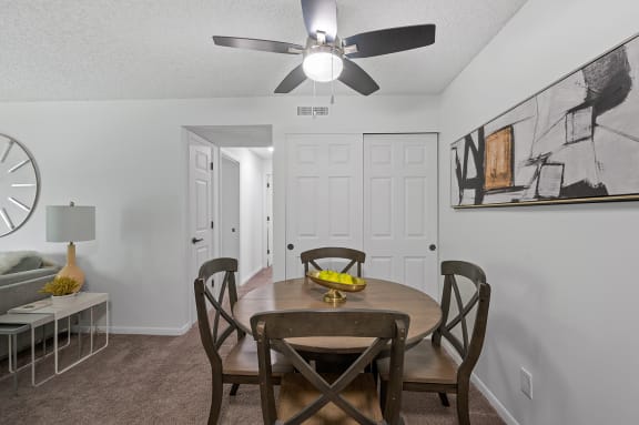our redesigned dining room with a table and chairs and a ceiling fan