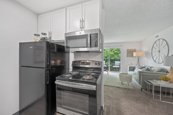 a kitchen with stainless steel appliances and a refrigerator