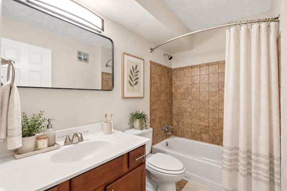 A bathroom with a white sink and a white toilet.