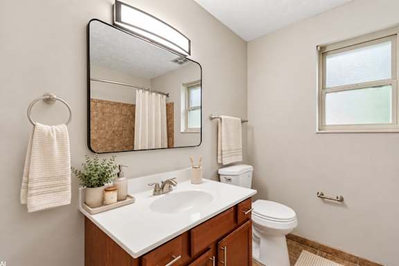 A bathroom with a white sink and a mirror above it.