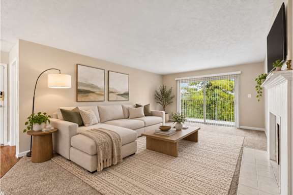 A living room with a couch, a coffee table, and a lamp.