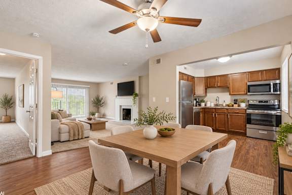 A modern dining room with a wooden table and chairs.