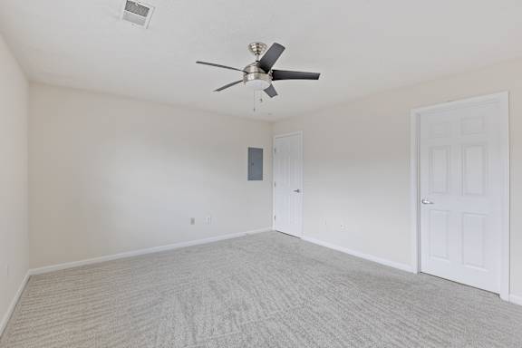 A room with a ceiling fan and two doors.