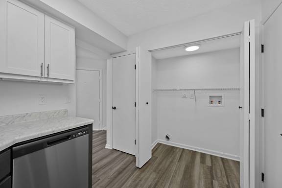 A kitchen with white cabinets and a black dishwasher at Indian Lookout Apartments, West Carrollton, OH
