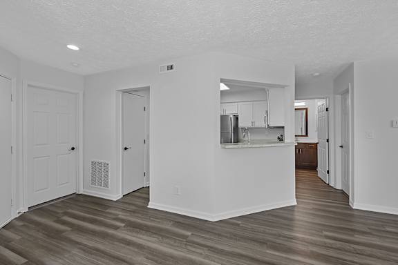 A kitchen area with a refrigerator, cabinets, and a countertop at Indian Lookout Apartments, Ohio