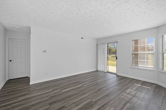 A room with a wooden floor and a sliding glass door at Indian Lookout Apartments, Ohio, 45449
