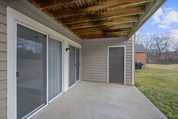 A patio with a sliding glass door and a wooden ceiling at Indian Lookout Apartments, Ohio