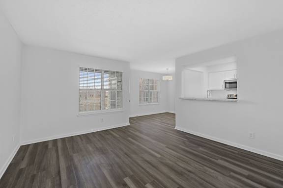 A room with wooden flooring and white walls at Indian Lookout Apartments, West Carrollton, OH, 45449