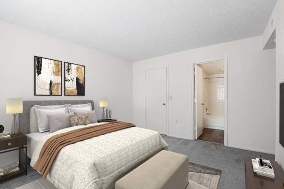 A bedroom with a large bed and two lamps on either side.