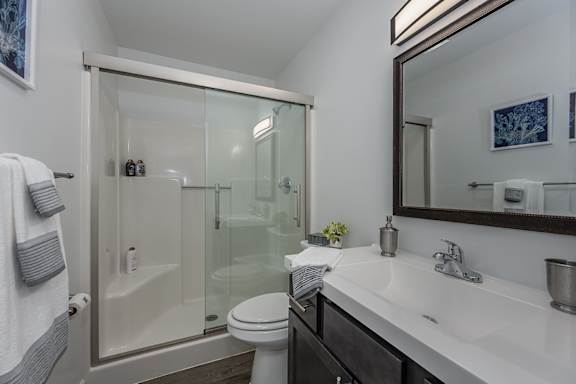 A white toilet sits next to a sink in a bathroom.
