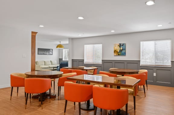a room with a table and chairs and a couch in the background at The Valley, Cincinnati